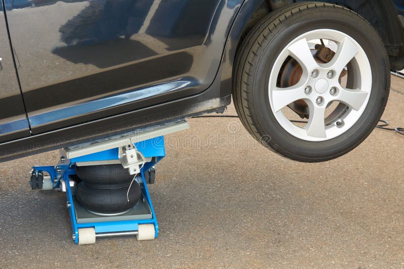 Tire Fitting with Pneumatic Jack Stock Image Image of garage