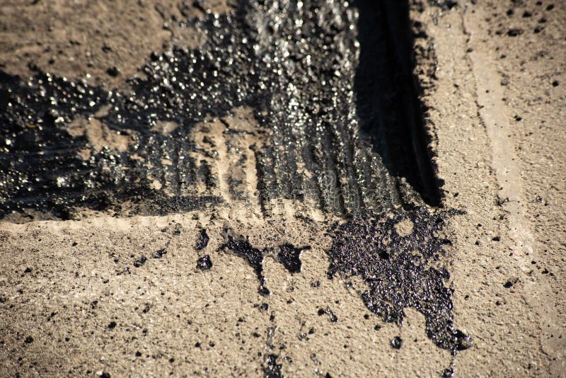 Tire tracks on bitumen on the surface of asphalt under construction stock images Tire tracks on bitumen on the surface of asphalt under construction stock images