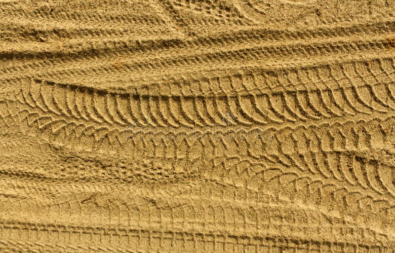 Tire tracks on sand.