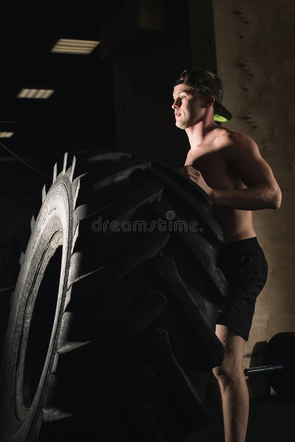 Tire Workout in gym stock photo. Image of practicing 105960466