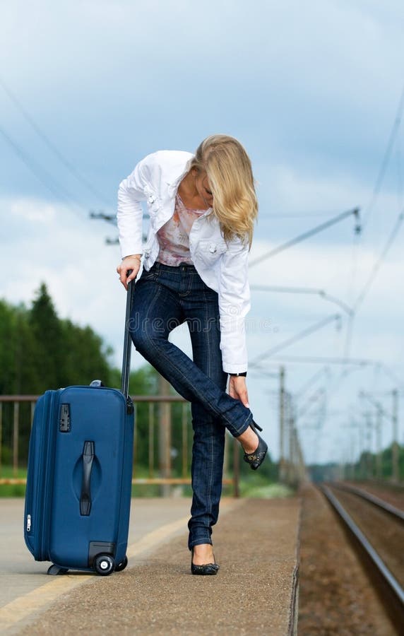 Tired beautiful young lady with suitcase