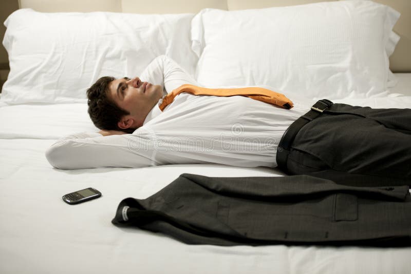 Tired Businessman Lying on Bed