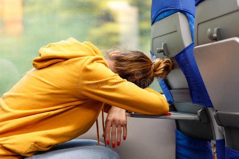 Tired exhausted young female after work asleep in train stock photo Tired exhausted young female after work asleep in train stock photo
