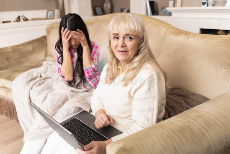 Smiling daughter teaches her senior mother how to use laptop royalty free stock photos Smiling daughter teaches her senior mother how to use laptop royalty free stock photos