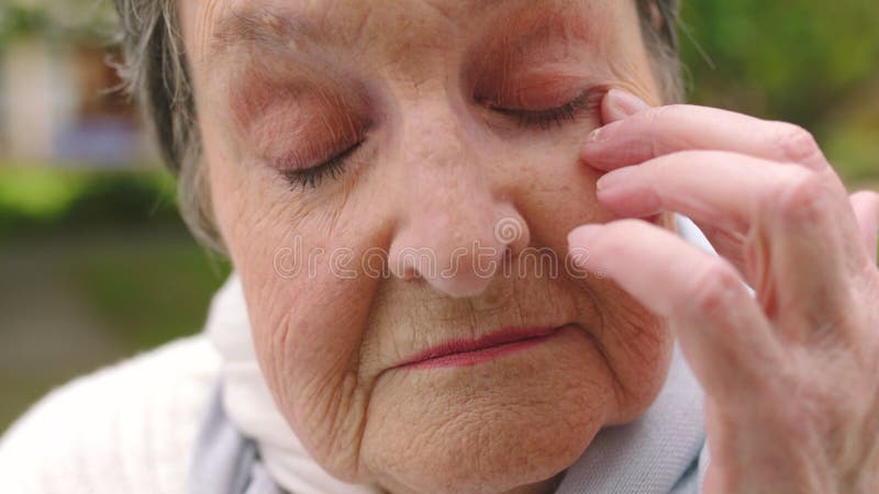 Tired face, senior portrait and woman with eye problem in retirement, crying with depression in nature and frustrated