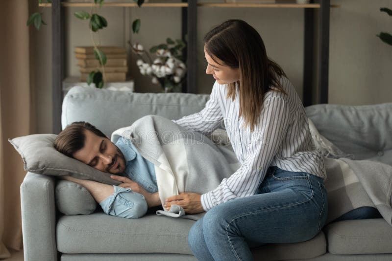 Caring Wife Covers Sleeping Man With Warm Cozy Plaid Stock Image
