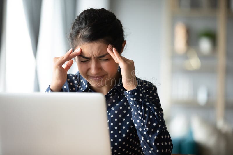 Tired Indian girl suffer from migraine at workplace. Exhausted millennial Indian girl touch massage temples suffer from headache or migraines, tired young ethnic stock images Tired Indian girl suffer from migraine at workplace. Exhausted millennial Indian girl touch massage temples suffer from headache or migraines, tired young ethnic stock images