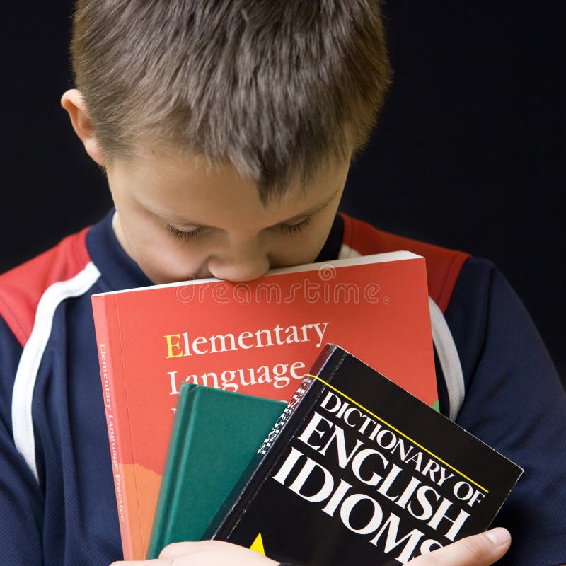 A teenage boy tired of learning English. Portrait isolated on black background. Square format photo. Boring kid white stock images, royalty-free photos and pictures