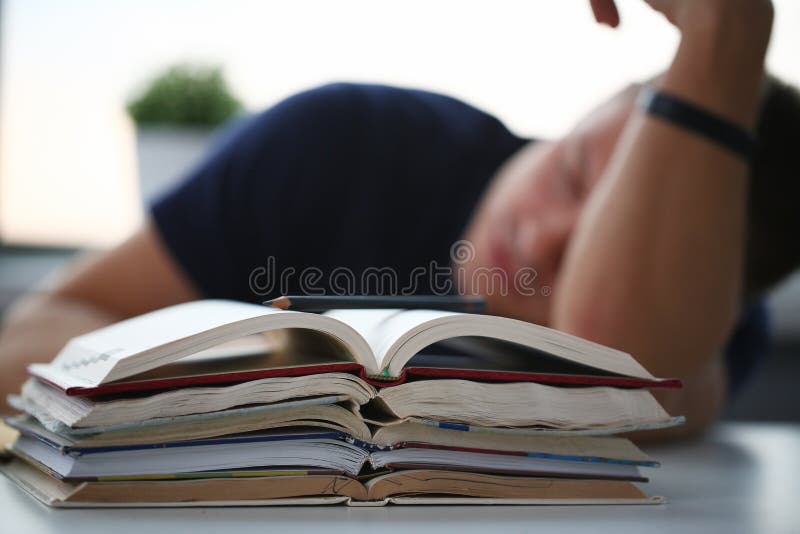 Tired male student at workplace in room royalty free stock image Tired male student at workplace in room royalty free stock image