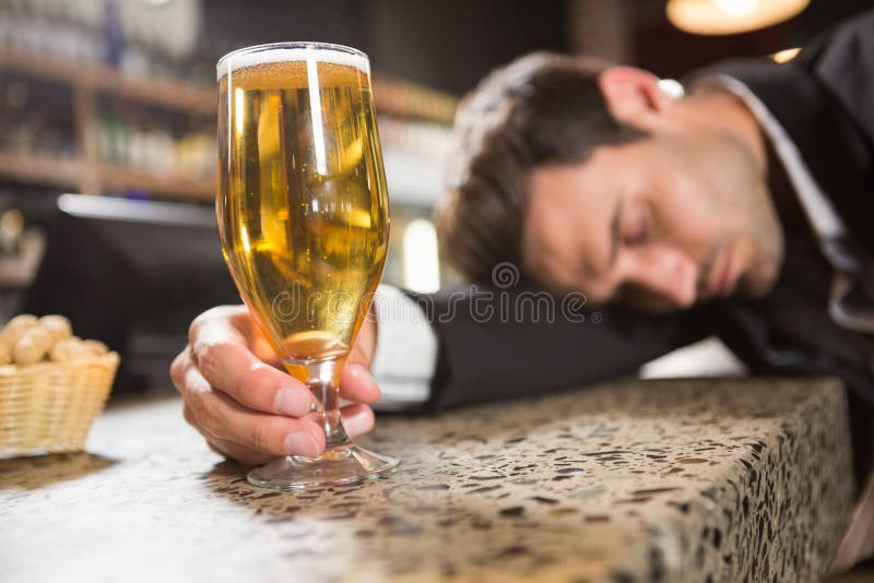 Tired man having a beer stock photo. Image of person - 67563662