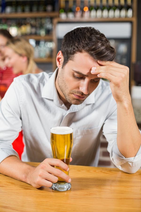 Tired man sitting in a bar stock photo. Image of leisure - 67729068