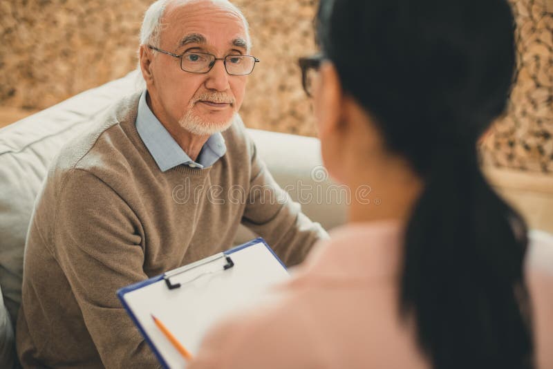 Senior with grey hair directly looking on dark-haired woman royalty free stock photos Senior with grey hair directly looking on dark-haired woman royalty free stock photos