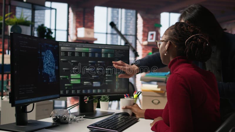 Tired overworked admin in AI startup office getting help from senior manger stock footage