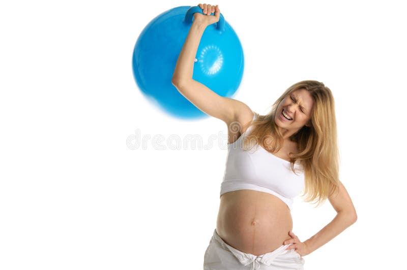 Tired pregnant woman picks up big blue ball