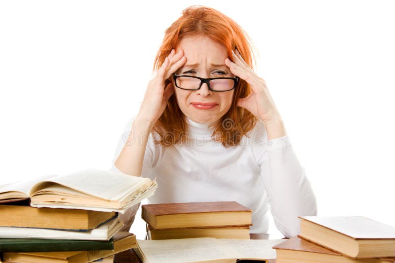 Tired red-haired girl in glasses with books