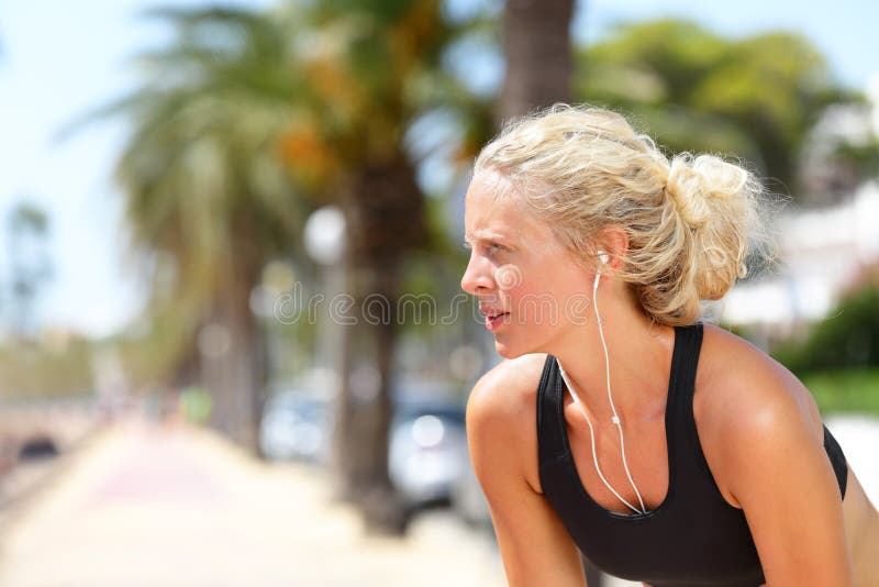 Tired running woman taking a break during run royalty free stock images Tired running woman taking a break during run royalty free stock images