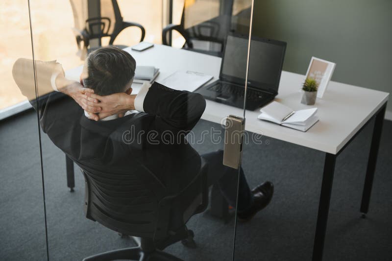 Tired Stressed Office Worker Sitting at Desk and Thinking, he is