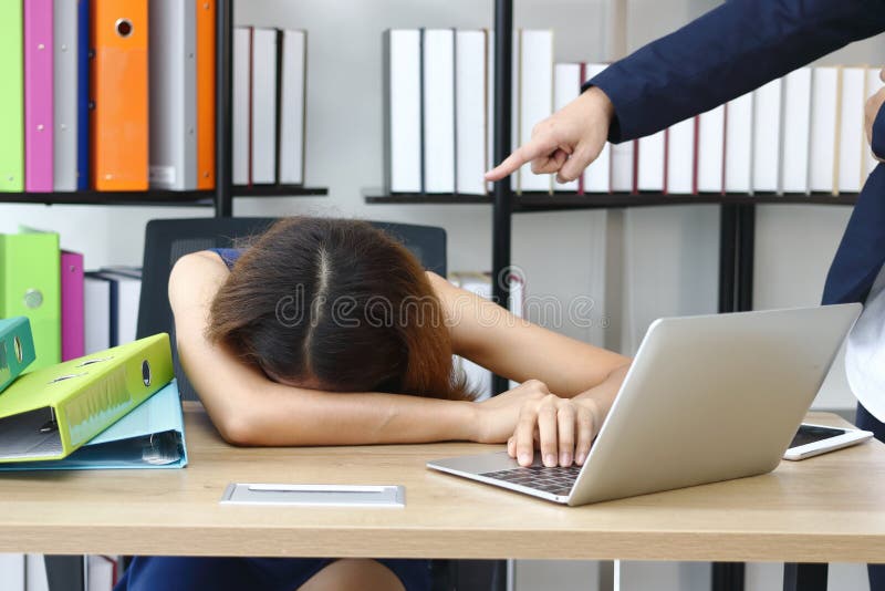 Tired stressed young Asian business bend down head with hand`s boss pointing in workplace