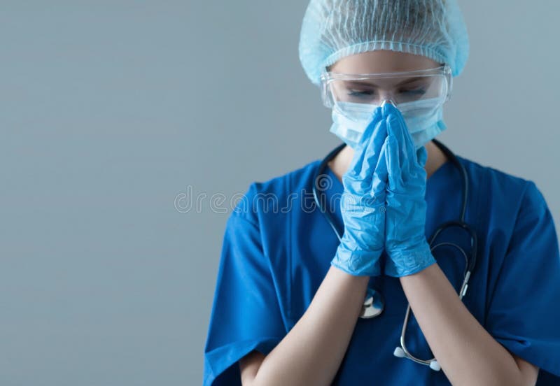 Tired, upset and depressed medical worker in protection suit. Nurse, surgeon, doctor or paramedic in blue uniform. Emergency medicine and ambulance concept.