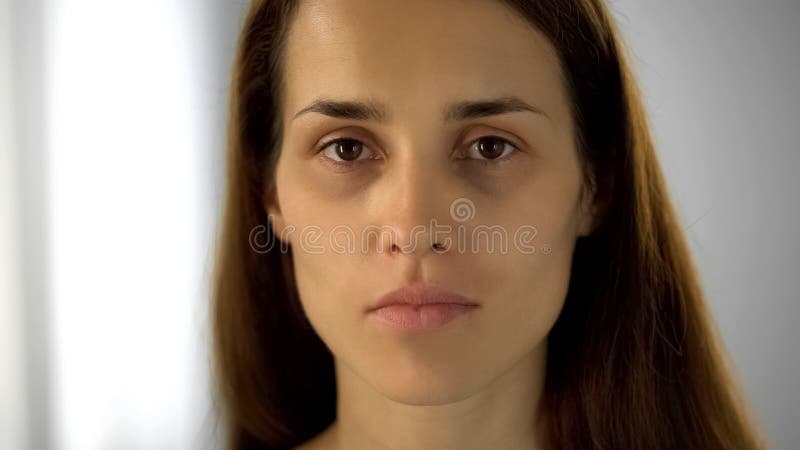 Tired woman with black circles under eyes looking at camera, lack of sleep royalty free stock photography Tired woman with black circles under eyes looking at camera, lack of sleep royalty free stock photography