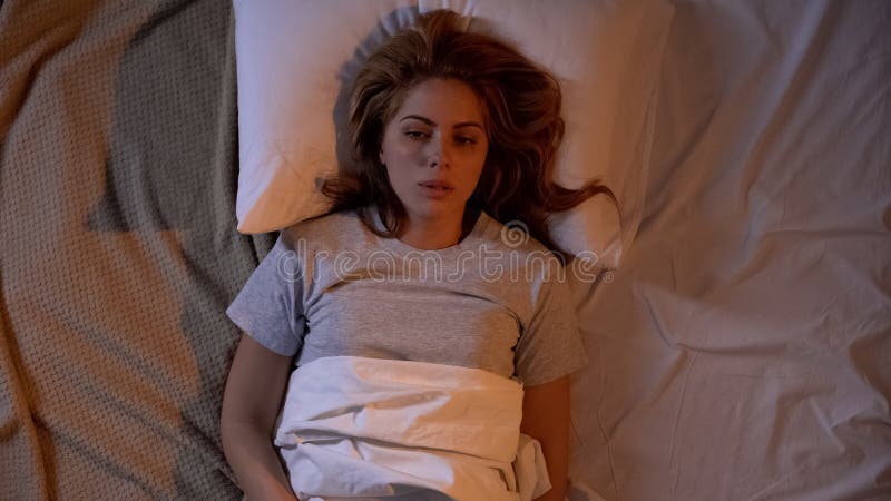 Tired woman trying to sleep, life difficulties, feeling lonely and frustrated stock images Tired woman trying to sleep, life difficulties, feeling lonely and frustrated stock images