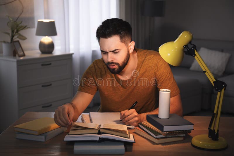 Tired Young Man with Energy Drink Studying at Home Stock Photo Image of homework, beverage