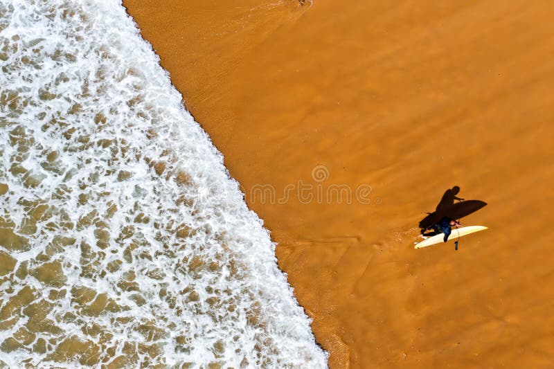 Aerial shot from a surfer coming out of the water from the atlantic ocean in Portugal Europe. Aerial shot from a surfer coming out of the water from the atlantic ocean in Portugal Europe
