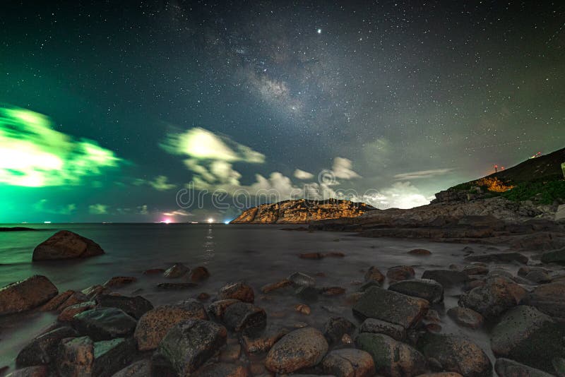 Tiro hermoso del mar con el cielo estrellado impresionante con las nubes y las rocas en la costa imagen de archivo Tiro hermoso del mar con el cielo estrellado impresionante con las nubes y las rocas en la costa imagen de archivo