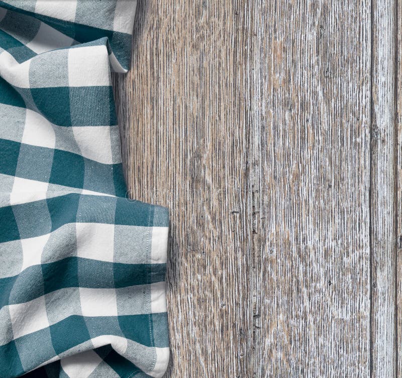 Picnic cloth over old wooden table grunge background. Picnic cloth over old wooden table grunge background