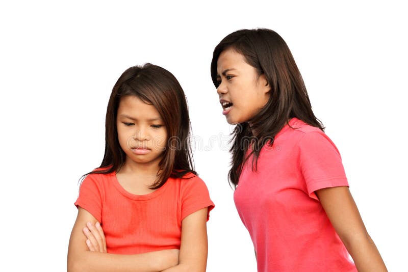 Asian teen shouting on her younger sister. Asian teen shouting on her younger sister