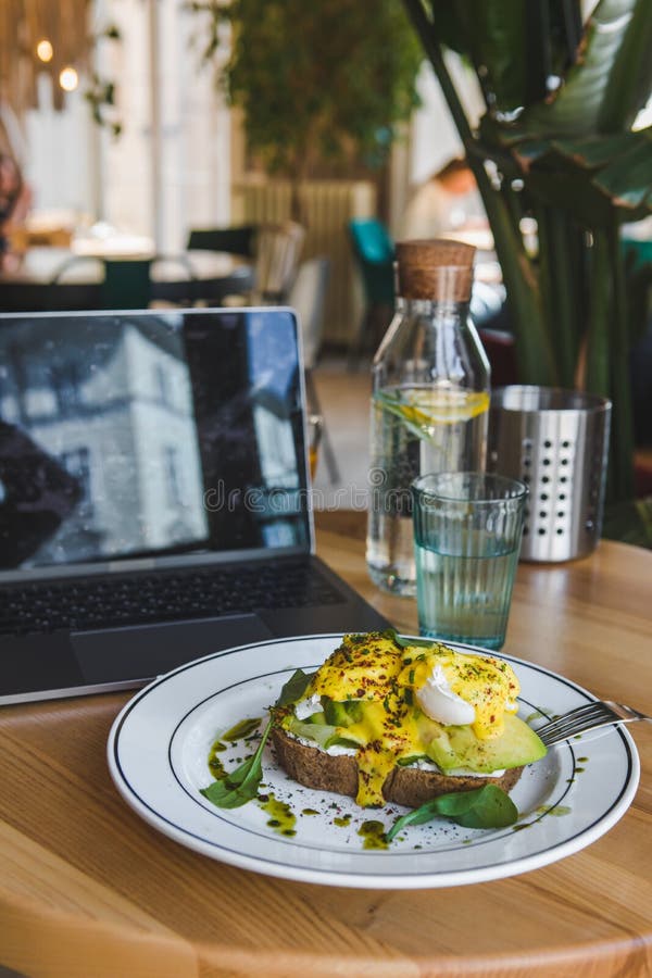 Toast with Avocado and Eggs on the Plate in Restaurant Stock Image