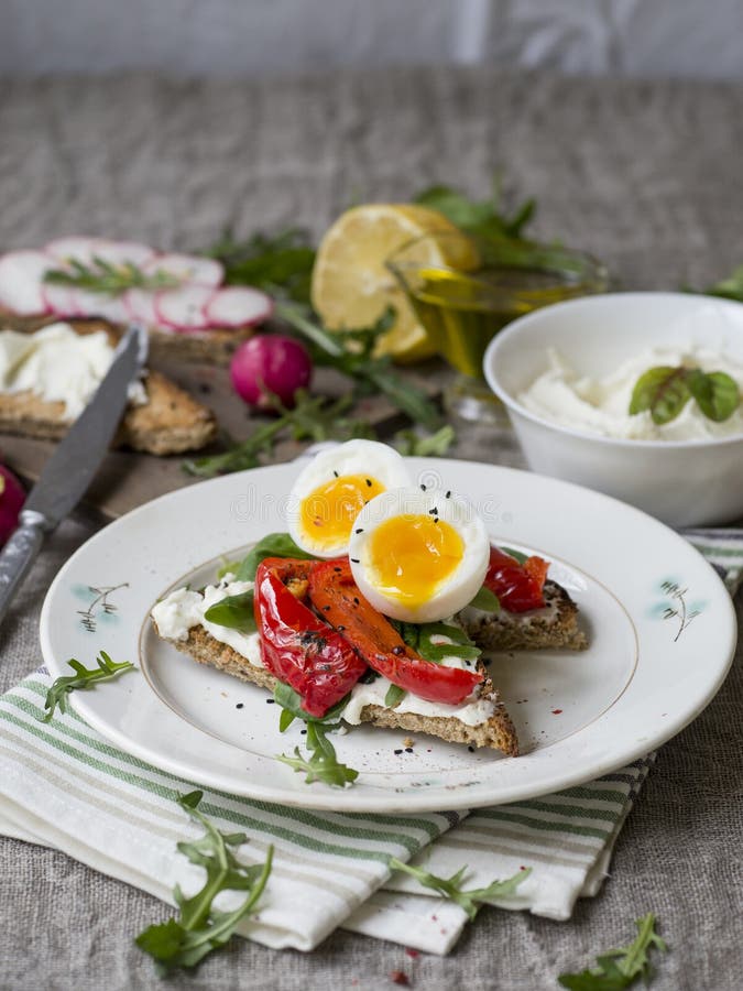 Toast with Egg, Red Pepper, Cheese and Rucola on a White Plate. Stock ...