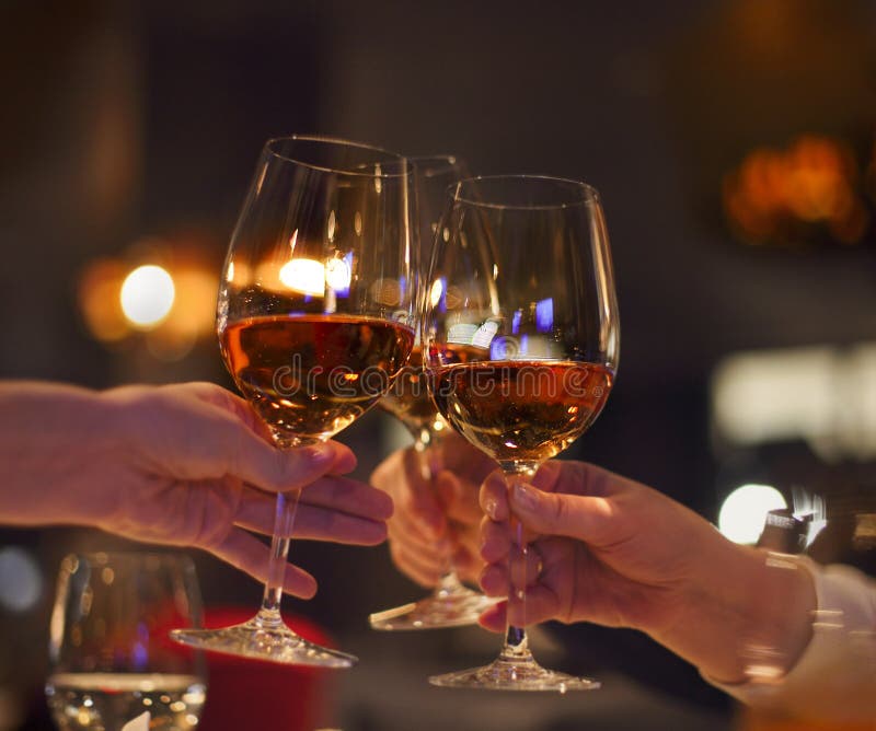 Toast in restaurant with full glasses of rose wine stock image Toast in restaurant with full glasses of rose wine stock image