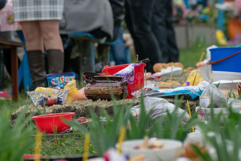 TOCUZ, MOLDOVA- 16 APRIL, 2018: Goods on the graves in the cemetery celebrating the dead during Memorial Easter