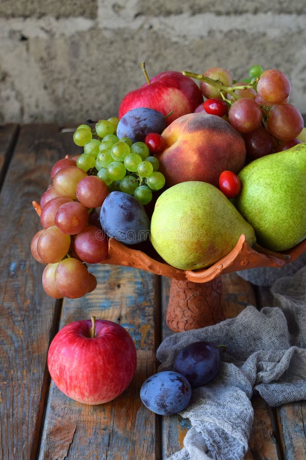 Todavía del otoño vida para la acción de gracias con las frutas y las bayas en fondo de madera - uvas, manzanas, ciruelos, viburn imágenes de archivo libres de regalías Todavía del otoño vida para la acción de gracias con las frutas y las bayas en fondo de madera - uvas, manzanas, ciruelos, viburn imágenes de archivo libres de regalías