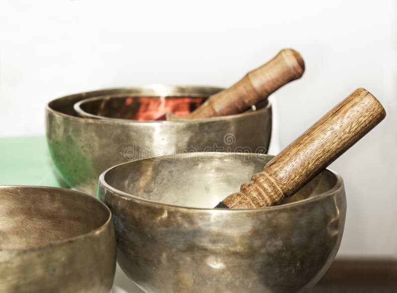 Still life photo with tibet singing bowls close up. Tibetian singing bowls in light blurry background.Asian music instruments. Meditation instruments. Still life photo with tibet singing bowls close up. Tibetian singing bowls in light blurry background.Asian music instruments. Meditation instruments