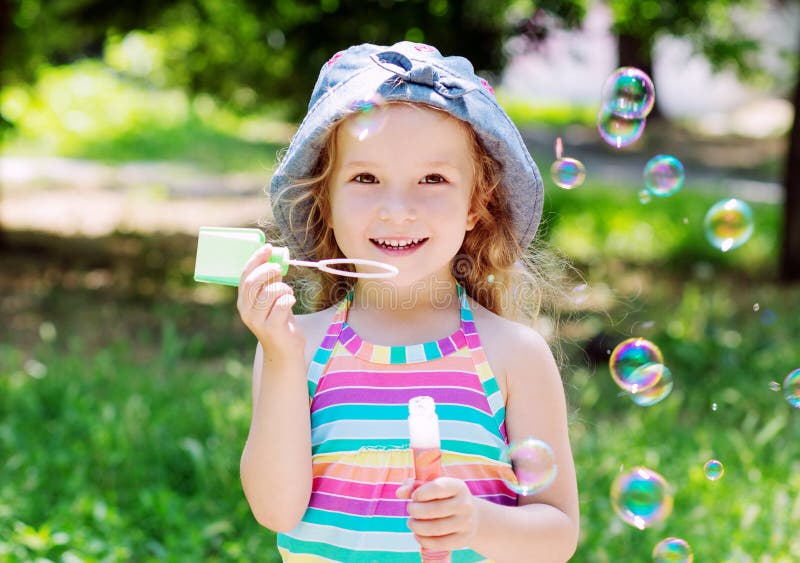 Portrait Of A Gorgeous Dreamy Young Teen Blowing Soap Bubbles Stock Photo