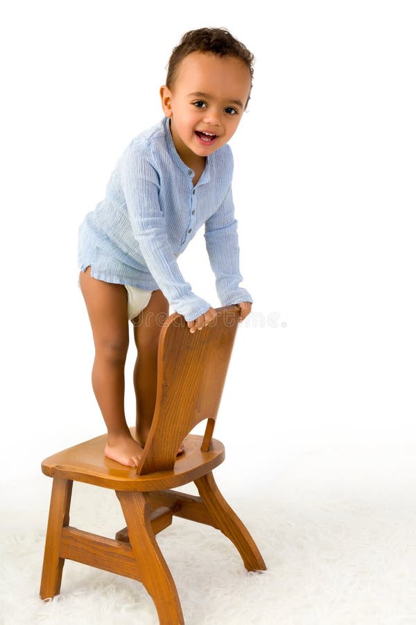 toddler climbing chair cheerful little month old boy standing small wooden 56807803