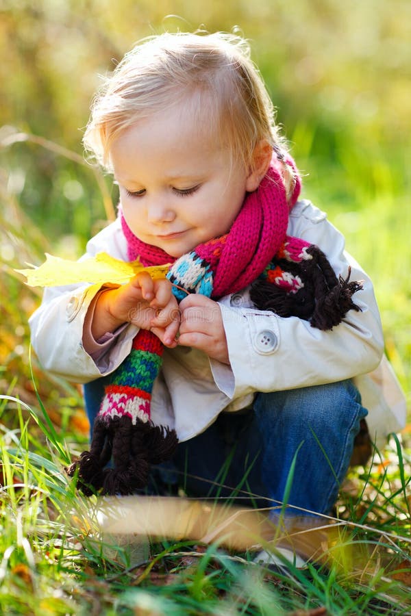 Toddler girl in autumn park