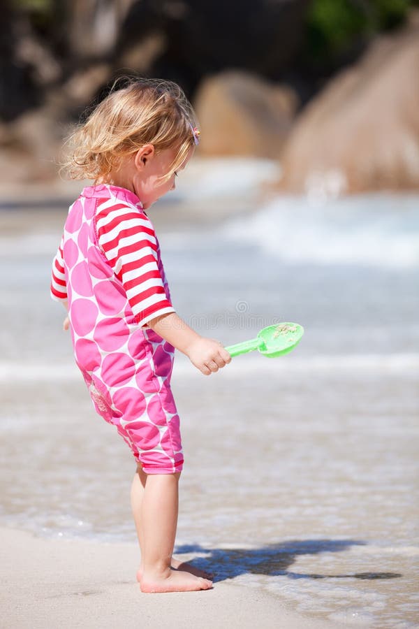Toddler girl at beach stock image. Image of coast, beach 18855403