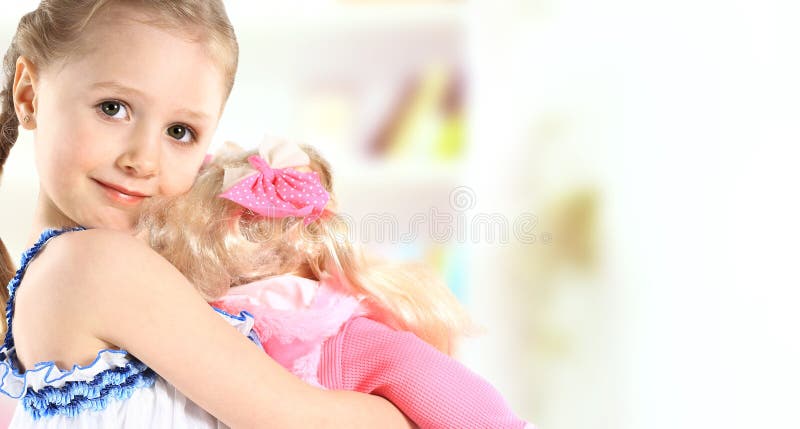 Toddler girl with doll on a white background. Lovely european female stock images, royalty-free photos and pictures