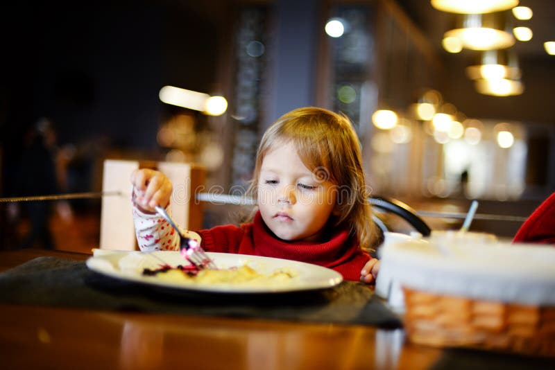 Toddler Girl Eating in Restaurant Stock Image - Image of horizontal ...
