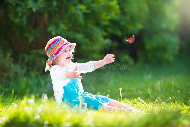 Toddler girl playing with butterfly