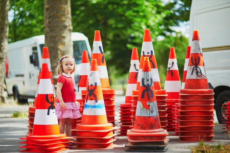 Chinese Girl Sits On Traffic Cone