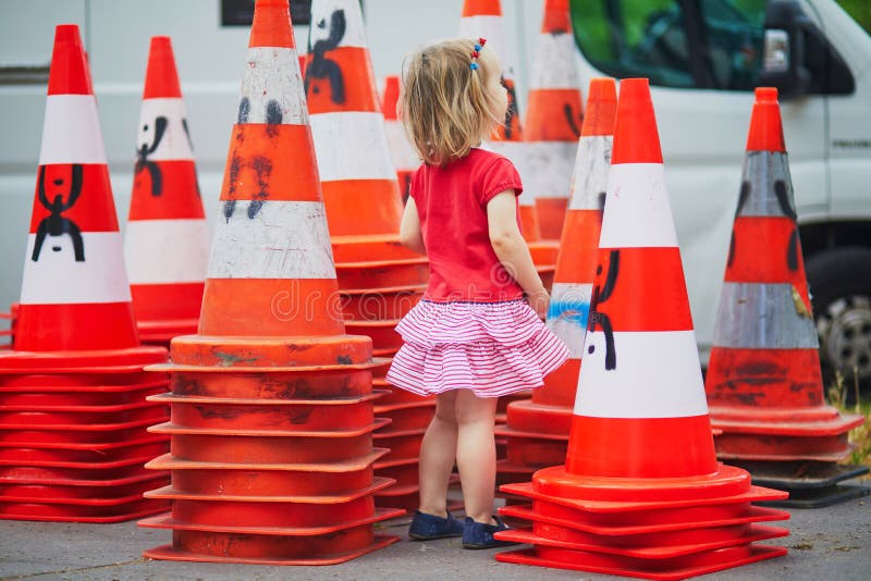 Chinese Girl Sits On Traffic Cone