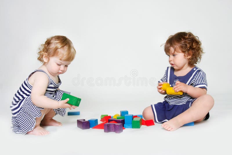 Toddler girls playing with building blocks