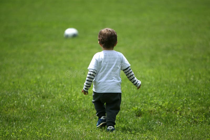 Toddler playing football