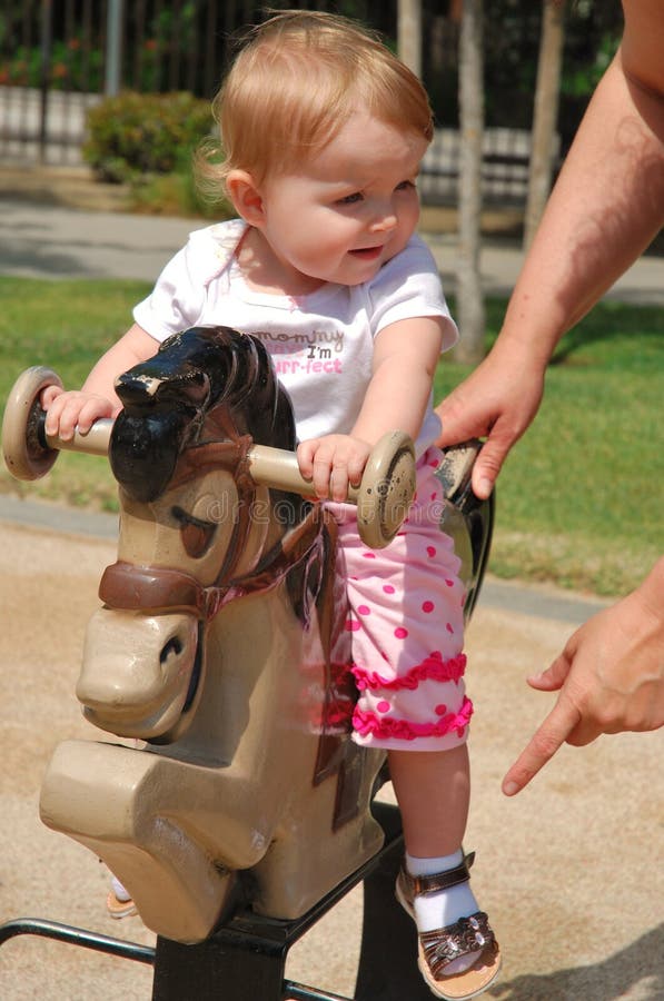 Toddler playing on horse tetter-totter