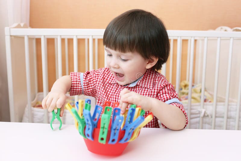 Toddler Plays with Clothes Pins Stock Image - Image of development ...