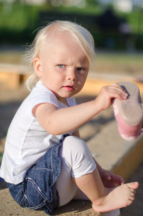 Toddler put on her shoes stock image. Image of learning 32040873